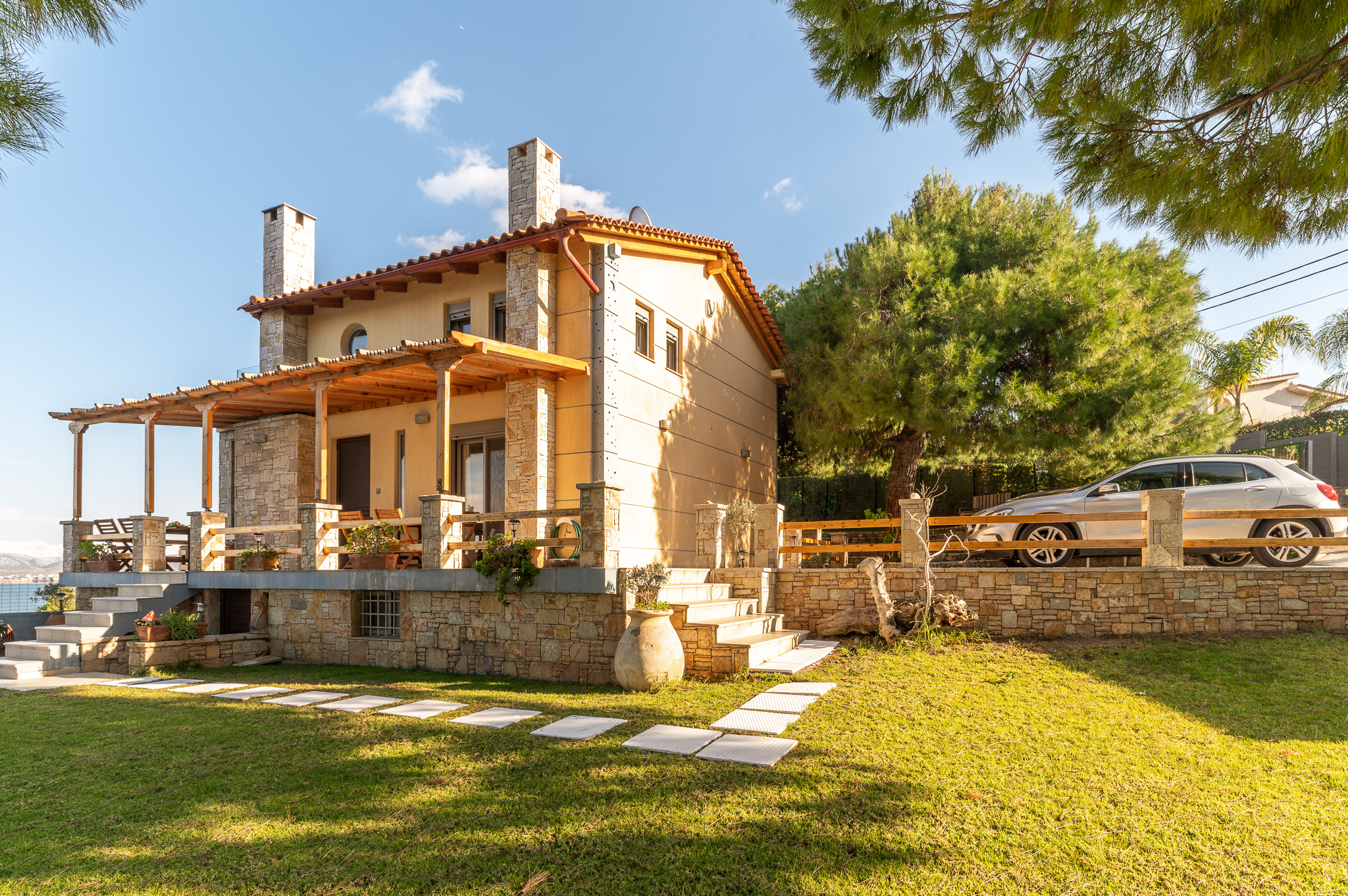 Crystal Beach Villa's modern architecture with large windows and a spacious outdoor area.