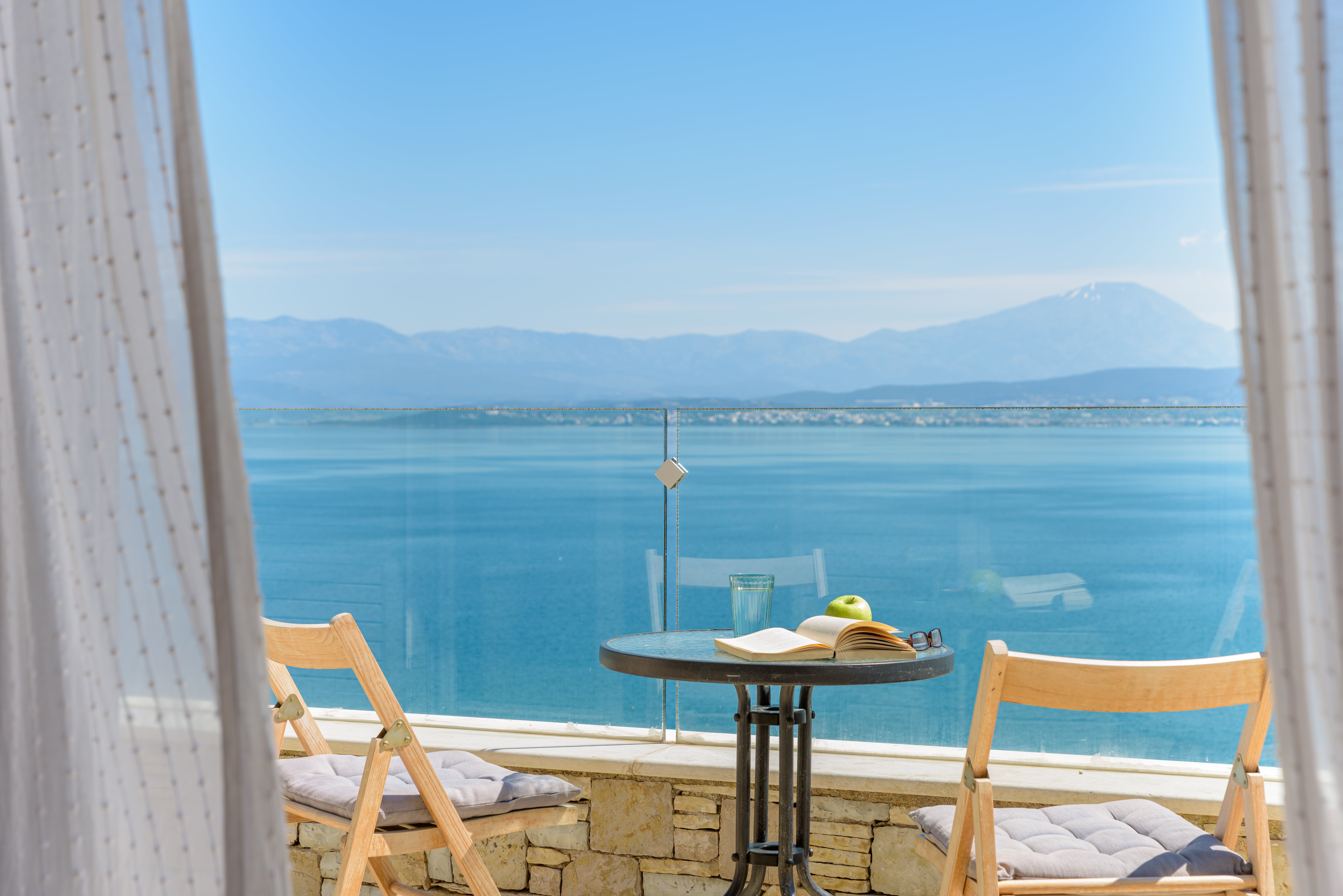 Balcony of Crystal Beach Villa room with breathtaking panoramic view of the Aegean Sea.