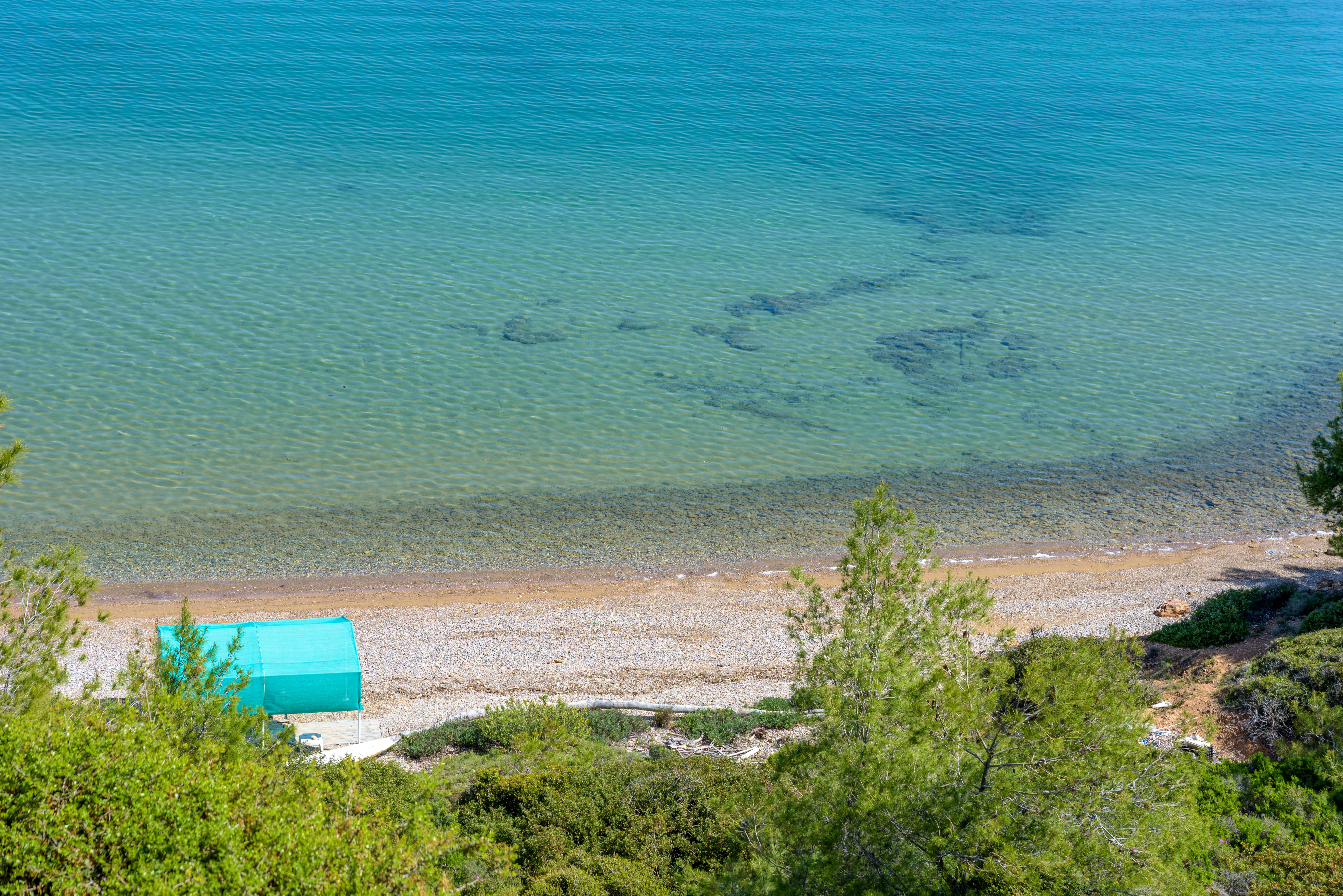 Private beach at Crystal Beach Villa, featuring pristine sand and crystal-clear waters, perfect for relaxation
