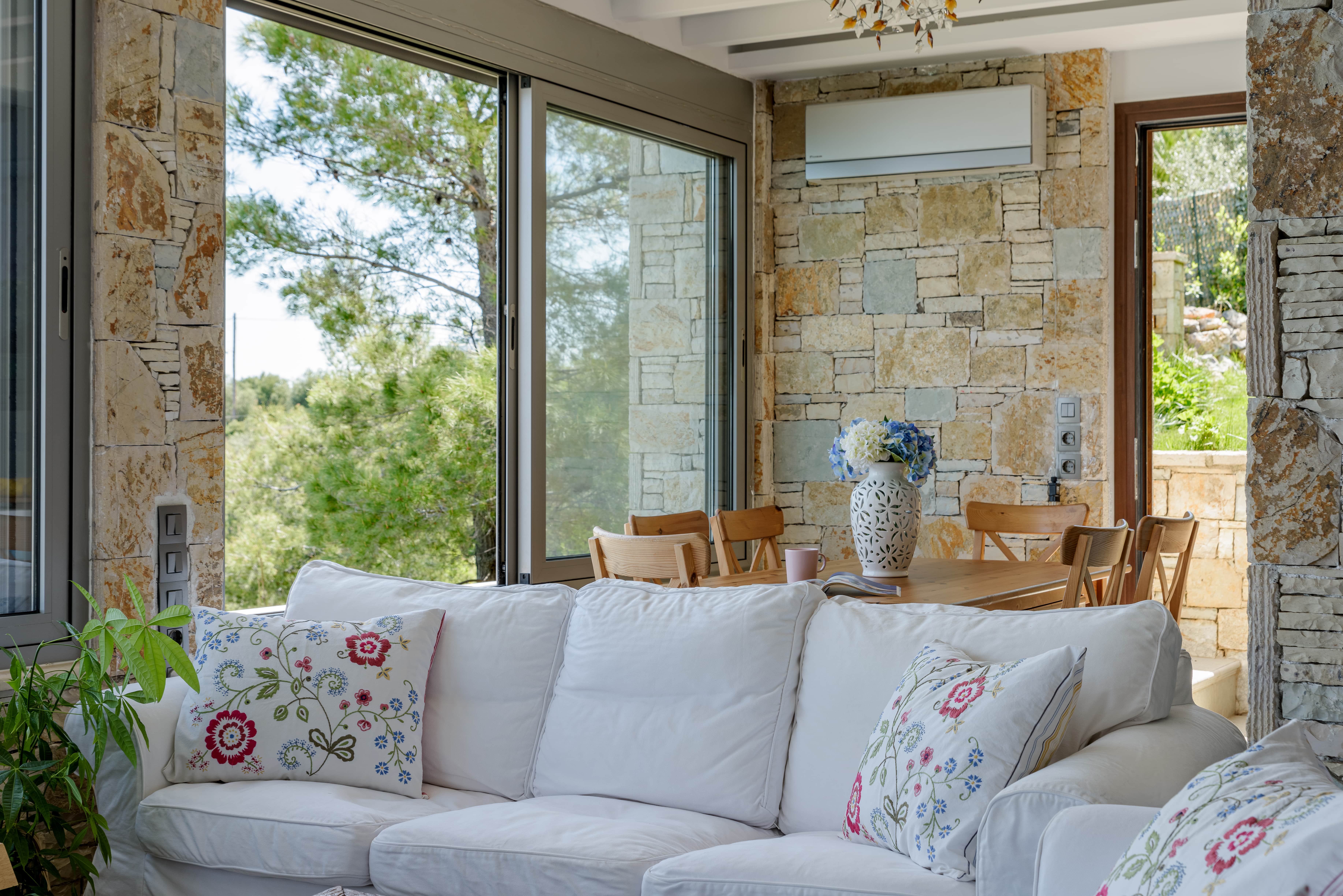 Modern and cozy living room in Crystal Beach Villa with panoramic windows offering ocean views.