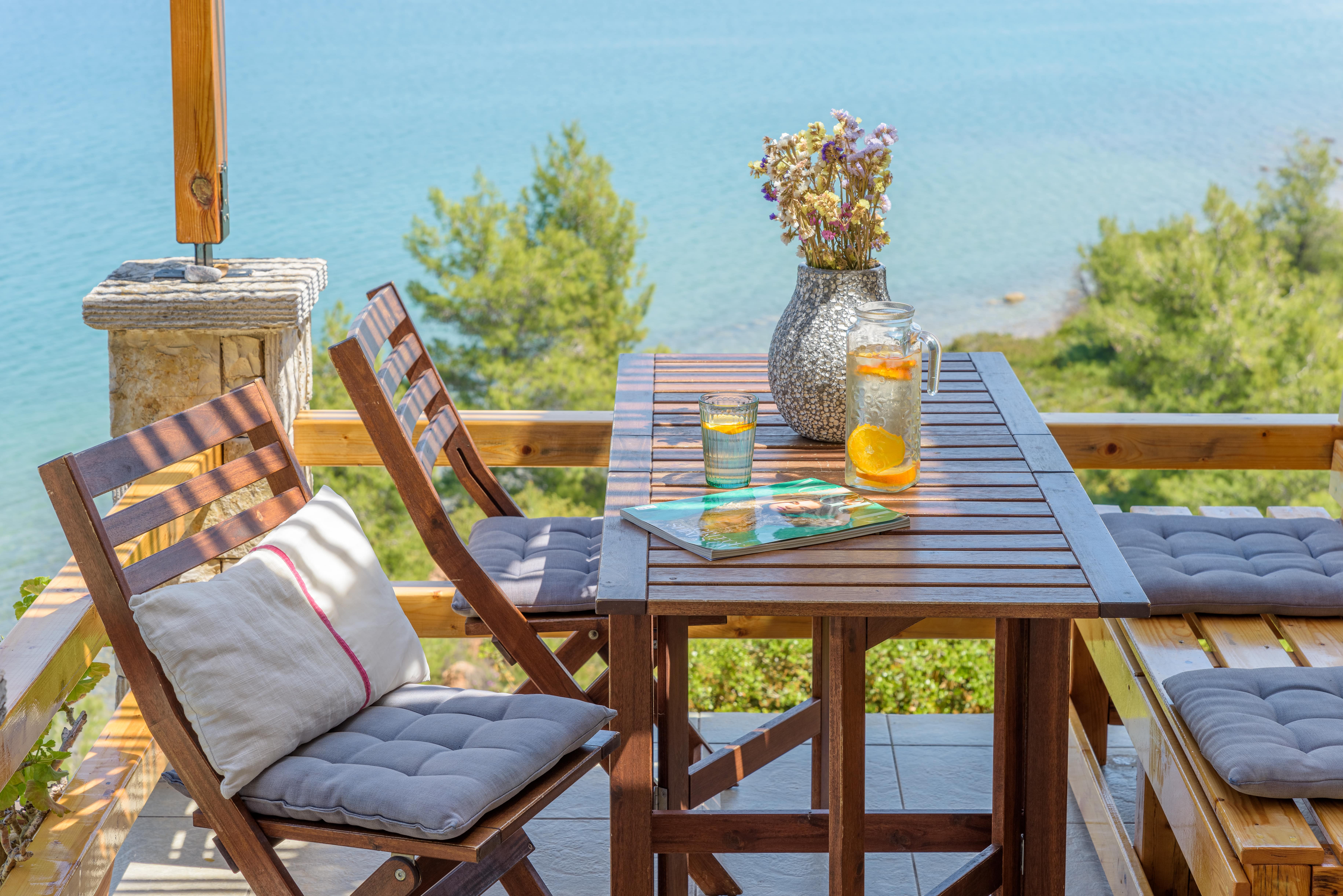 Outdoor dining area at Crystal Beach Villa with a table and chairs, perfect for al fresco meals.